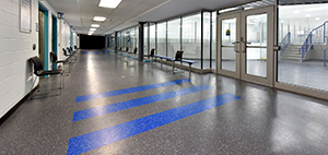 Hallway in arena with skate-resitant MaxFlor+ rubber flooring